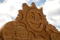 Sand sculpture of a huge happy smiley face