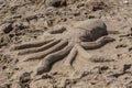 Sand sculpture of an octopus on the sea beach on a sunny day Royalty Free Stock Photo