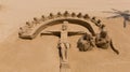 Sand sculpture of a religious scene Christ on cross on sandy beach