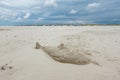 Sand sculpture of sawfish or shark on Kniepsand beach, Wittdun on Amrum island, North Frisia, Schleswig-Holstein, Germany Royalty Free Stock Photo