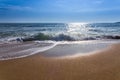 Sand sea beach and blue sky after sunrise and splash of seawater Royalty Free Stock Photo