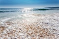 Sand sea beach and blue sky after sunrise and splash of seawater Royalty Free Stock Photo