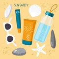 On sand are sea stones, shells and everything necessary for health on beach. Sun safety collection. Sunscreen cosmetics