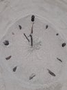 Sand and stick beach clock face 11 o clock Royalty Free Stock Photo