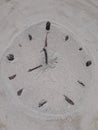 Sand and stick beach clock face 8 o clock Royalty Free Stock Photo