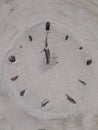 Sand and stick beach clock face 12 o clock Royalty Free Stock Photo