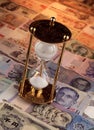 Sand timer on foreign currencies notes Royalty Free Stock Photo