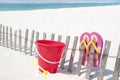 Sand toy and sandals at beach Royalty Free Stock Photo