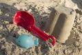 Sand toys, a red bucket and a scoop on the sand, Royalty Free Stock Photo