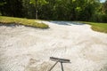 Sand trap, rake in a golf course sand bunkers, raking the sand