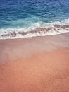 Sand and water texture. Soft sea foam wave on the golden sandy beach. Summer holiday refreshment background