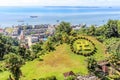 Sandakan town landscape with green lawn in Hindu counterclockwise swastika shape and blue Sulu sea in Royalty Free Stock Photo
