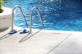 Sandal near the swimming pool ladder Royalty Free Stock Photo