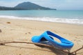 Sandals azure old condition and dirty with sand is  on beach sand sandy background Royalty Free Stock Photo