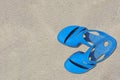 Sandals azure old condition and dirty with sand is  on beach sand sandy background Royalty Free Stock Photo