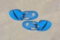 Sandals azure old condition and dirty with sand is  on beach sand sandy background Royalty Free Stock Photo