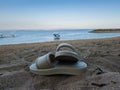 Sandals on beach sand in Sindhu Beach Bali