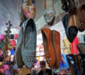 Sandals hanging in the shop to attract the customer for sale.