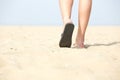 Sandals walking on sand at the beach Royalty Free Stock Photo