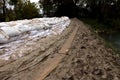 Sandbags flood protection on a muddy levy