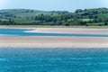 A sandbank at low tide, spring day. The sea water is a beautiful turquoise color. Sea coast, landscape