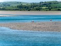 A sandbank at low tide on a sunny spring day. The sea water is a beautiful turquoise color. Sea coast, landscape