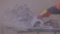 Sandblast metal parts. The man is sandblasting the detail. Sandblasting gun