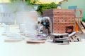 Sandblasting at an industrial plant, a worker knocks down oxide and dirty rust with sand under air pressure from a hose