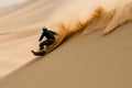 sandboarder sliding down a steep dune Royalty Free Stock Photo