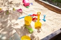 Sandbox outdoor. Children`s wooden sandbox with various toys for the game Royalty Free Stock Photo
