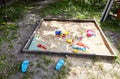 Sandbox outdoor. Children`s wooden sandbox with various toys for the game Royalty Free Stock Photo