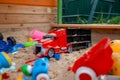 Children's wooden sandbox with various toys for the game. Royalty Free Stock Photo