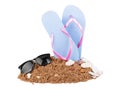 Sandcastle and beach shovels on white