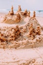 A sandcastle on a sandy beach, set against a bright blue summer sky. Royalty Free Stock Photo