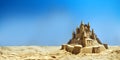 Sandcastle by the sea in the summer holiday, blue ocean and sky background with copy space. sandcastle on the seaside,playful, Royalty Free Stock Photo