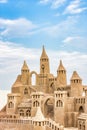 Sandcastle during a sunny day with blue sky background. Concept for summer, vacation and fun Royalty Free Stock Photo