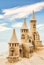 Sandcastle during a sunny day with blue sky background. Concept for summer, vacation and fun Royalty Free Stock Photo