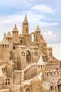 Sandcastle during a sunny day with blue sky background. Concept for summer, vacation and fun Royalty Free Stock Photo