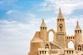 Sandcastle during a sunny day with blue sky background. Concept for summer, vacation and fun Royalty Free Stock Photo