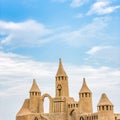 Sandcastle during a sunny day with blue sky background. Concept for summer, vacation and fun Royalty Free Stock Photo