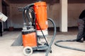 The sanded concrete screed is vacuumed with an industrial vacuum cleaner Royalty Free Stock Photo