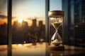 sandglass with a blurred background of a high-rise office view