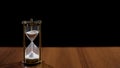 Sandglass measuring time by sand flow, life passing quickly, time management