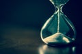 A sandglass, modern hourglass or egg timer with shadow showing the last second or last minute or time out. Royalty Free Stock Photo