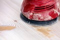 Sanding a board with an random orbital sander or rotary sander Royalty Free Stock Photo