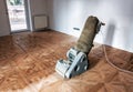 Sanding hardwood floor with the grinding machine