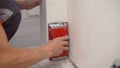 Wall sanding process. Preparation before painting. Home renovation concept. Sanding walls after plastering. The