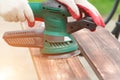 Sanding a wood with orbital sander Royalty Free Stock Photo