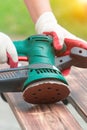 Sanding a wood with orbital sander Royalty Free Stock Photo