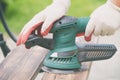 Sanding a wood with orbital sander Royalty Free Stock Photo